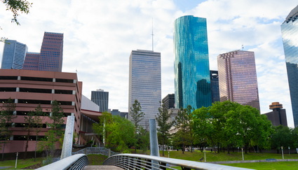 Green foreground with buildings in background