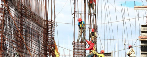 Workers erecting a building framework